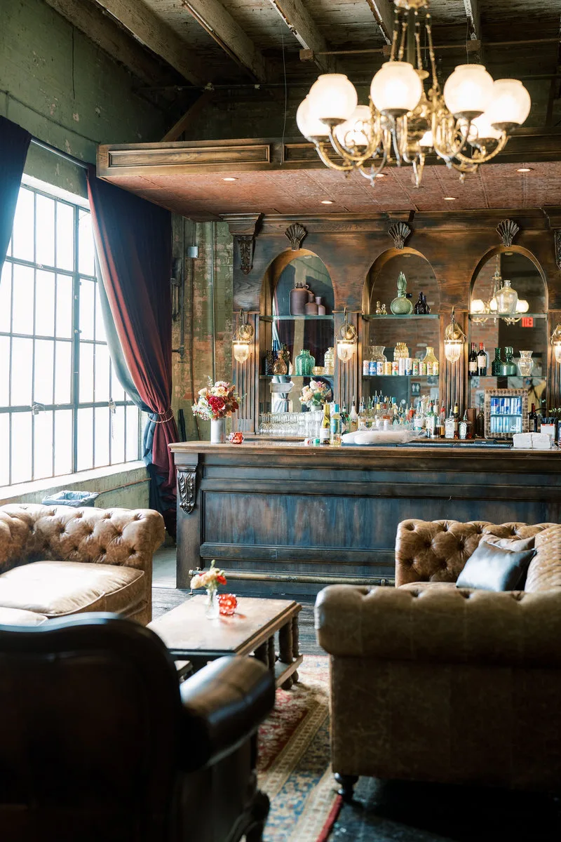 A chandelier-lit vintage bar with leather chesterfields inside Gilley’s Dallas