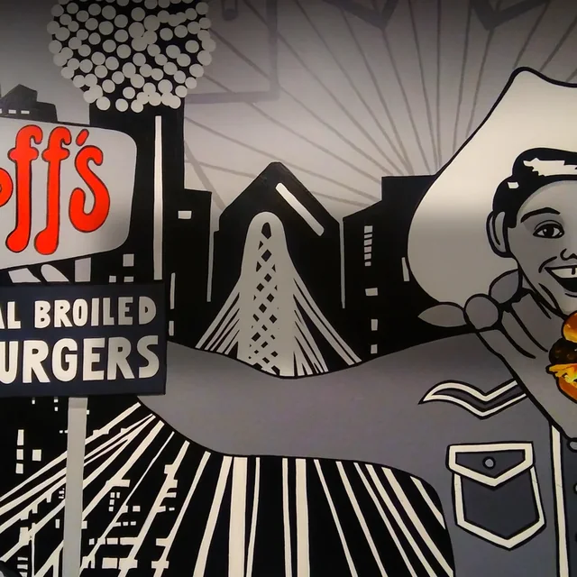 The retro Goff’s Hamburgers wall mural with a cowboy and the vintage charcoal-burgers sign