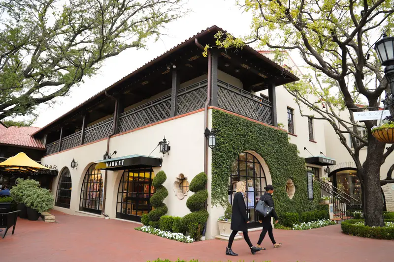 Shoppers outside the Highland Park Village shopping center
