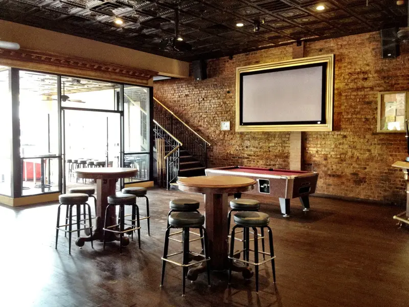 Tall tables and a pool table inside JR’s Bar & Grill