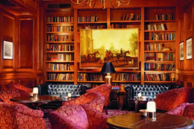 Leather couches and bookshelves in The Library Bar
