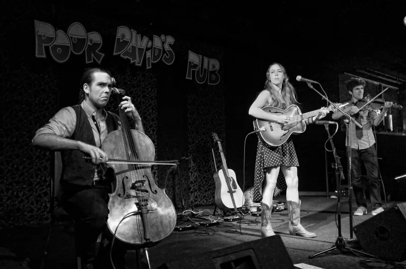 A trio performing on the Poor David’s Pub stage