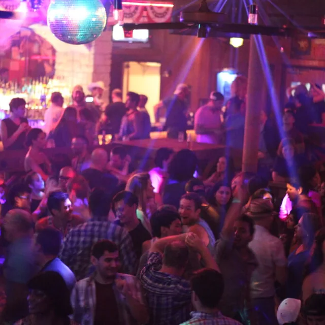 A packed dance floor under the disco ball at the Round-Up Saloon