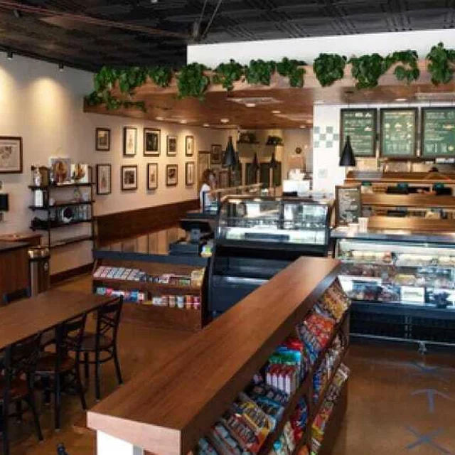 Inside Shug’s Bagels, with deli cases and a long wooden counter