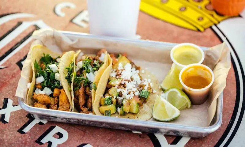 Three tacos with salsas and limes from Taqueria La Ventana