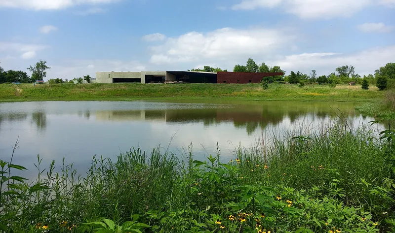 The Trinity River Audubon Center beyond a wetland pond in the Great Trinity Forest