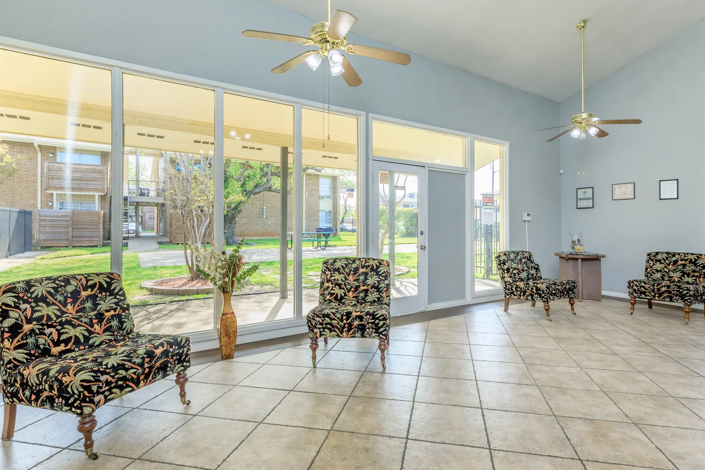 Clubhouse sunroom with floor-to-ceiling windows and lounge seating