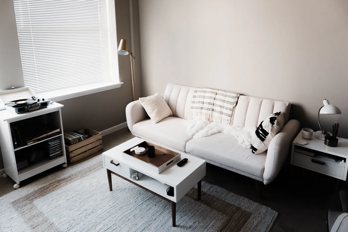 Furnished living area with a white sofa and coffee table