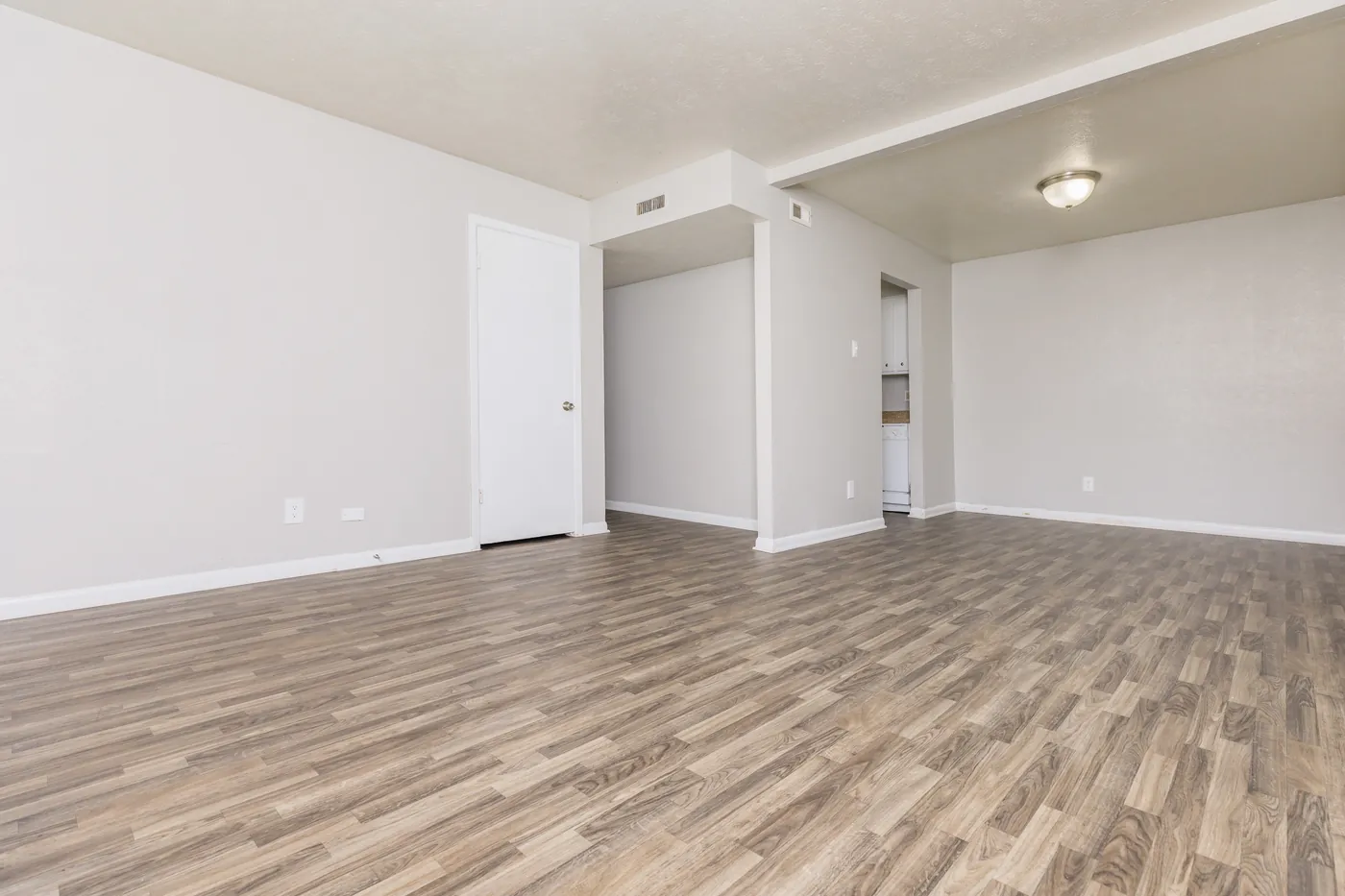 Open living and dining area with wood-look flooring